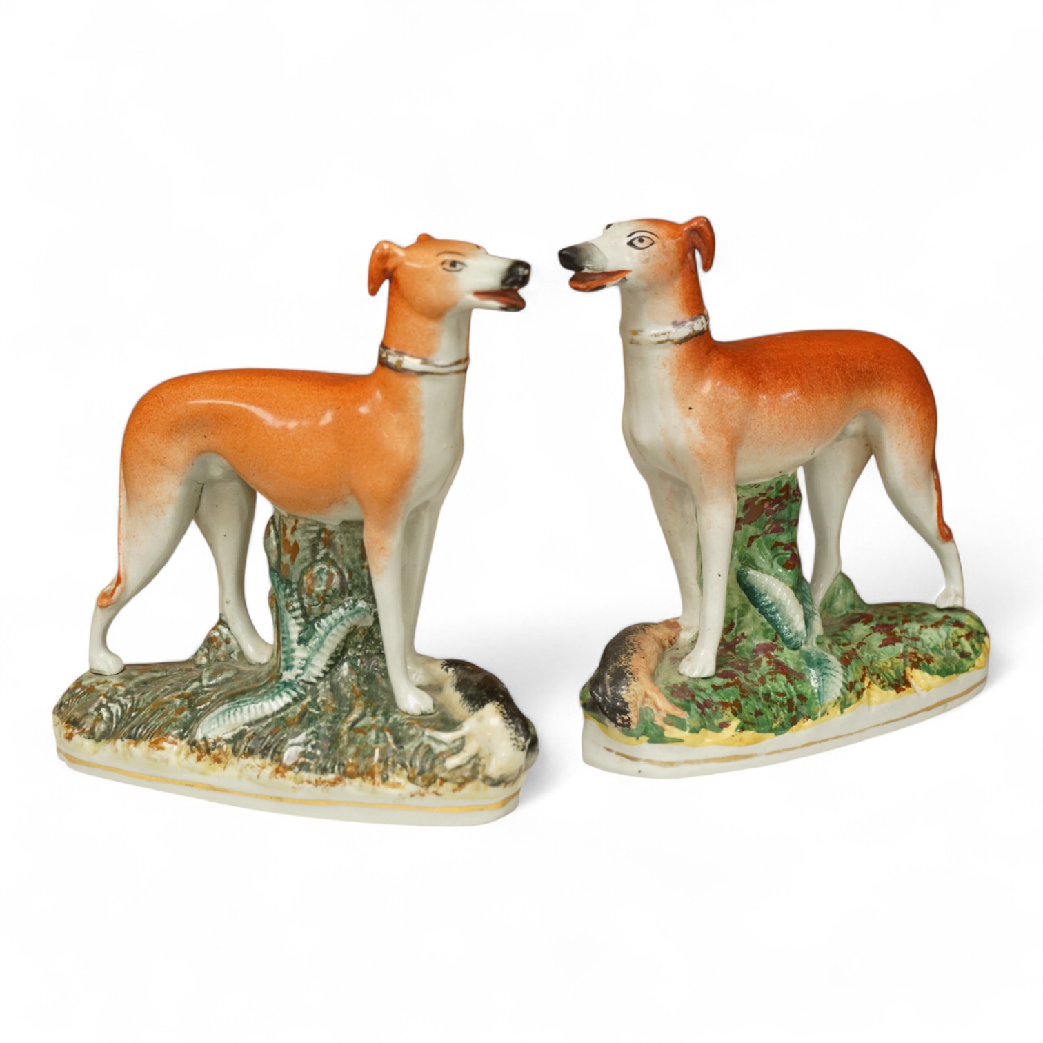 A pair of Staffordshire whippets, 19th century, one damaged, 19cm wide
